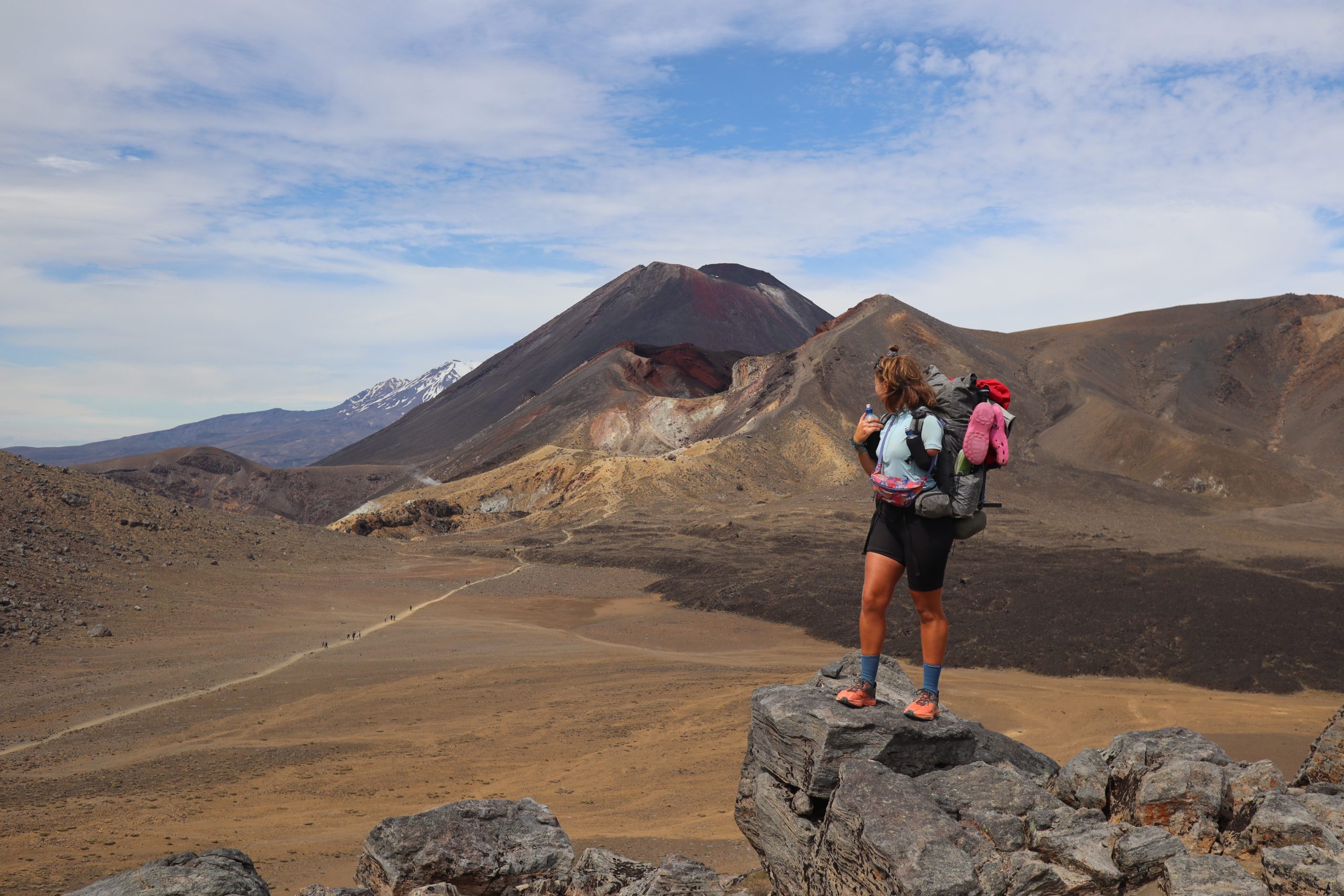 Ellie standing a top a rock looking out at the view on the Te Araroa trail