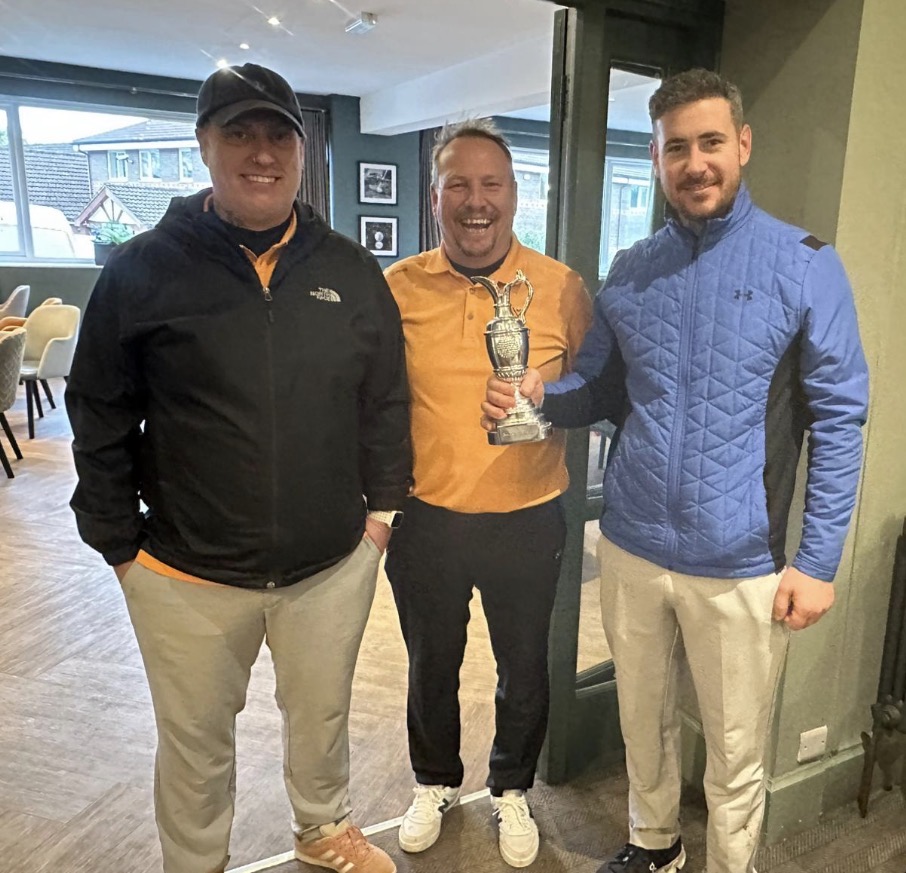 golf players holding the trophy